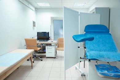 Photo of Gynecological clinic interior with chair and doctor's workplace