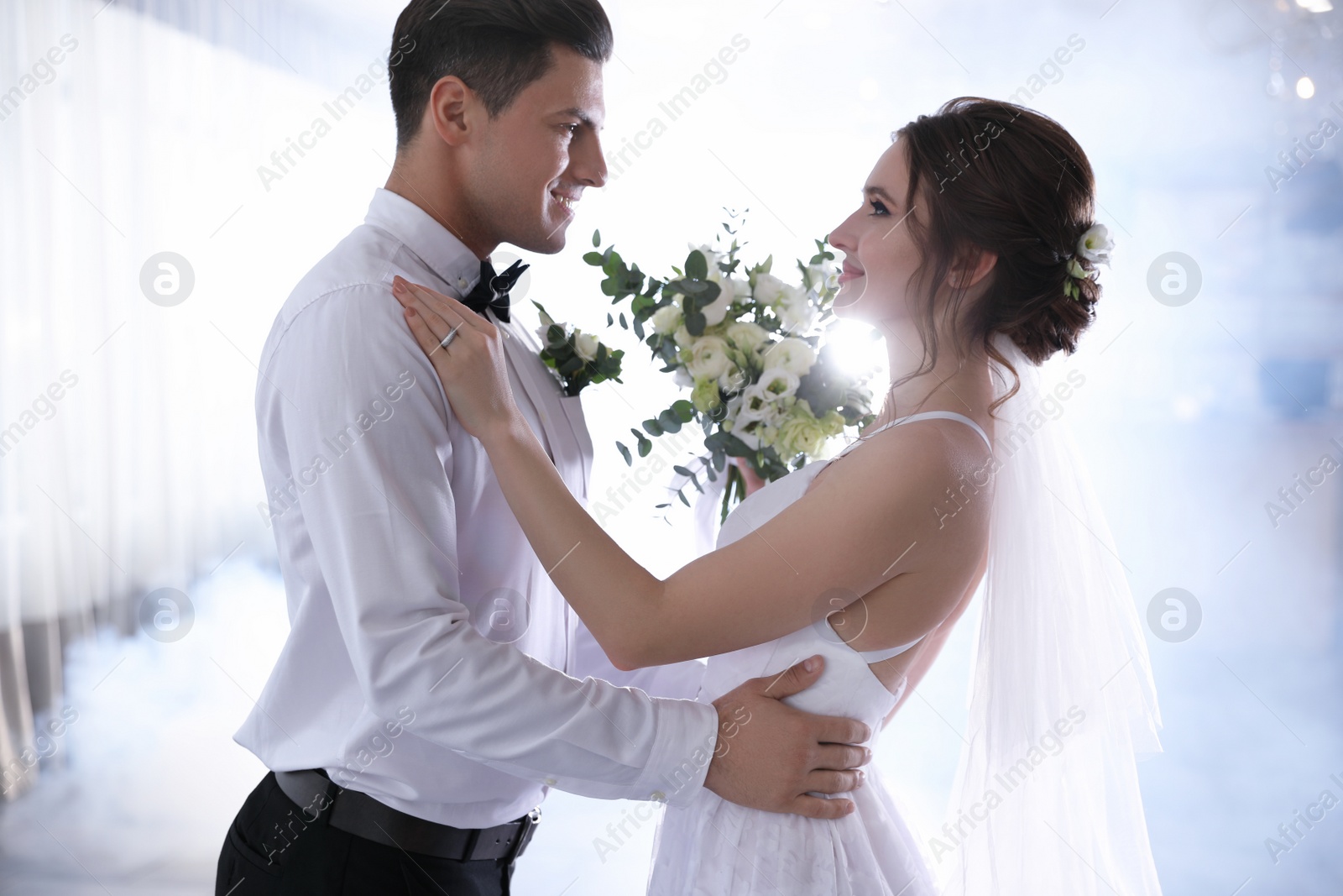 Photo of Happy newlywed couple dancing together in festive hall