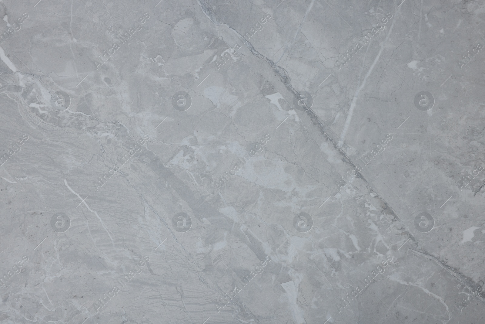 Photo of Texture of light grey marble surface as background, closeup