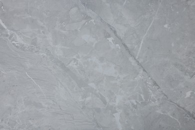 Photo of Texture of light grey marble surface as background, closeup