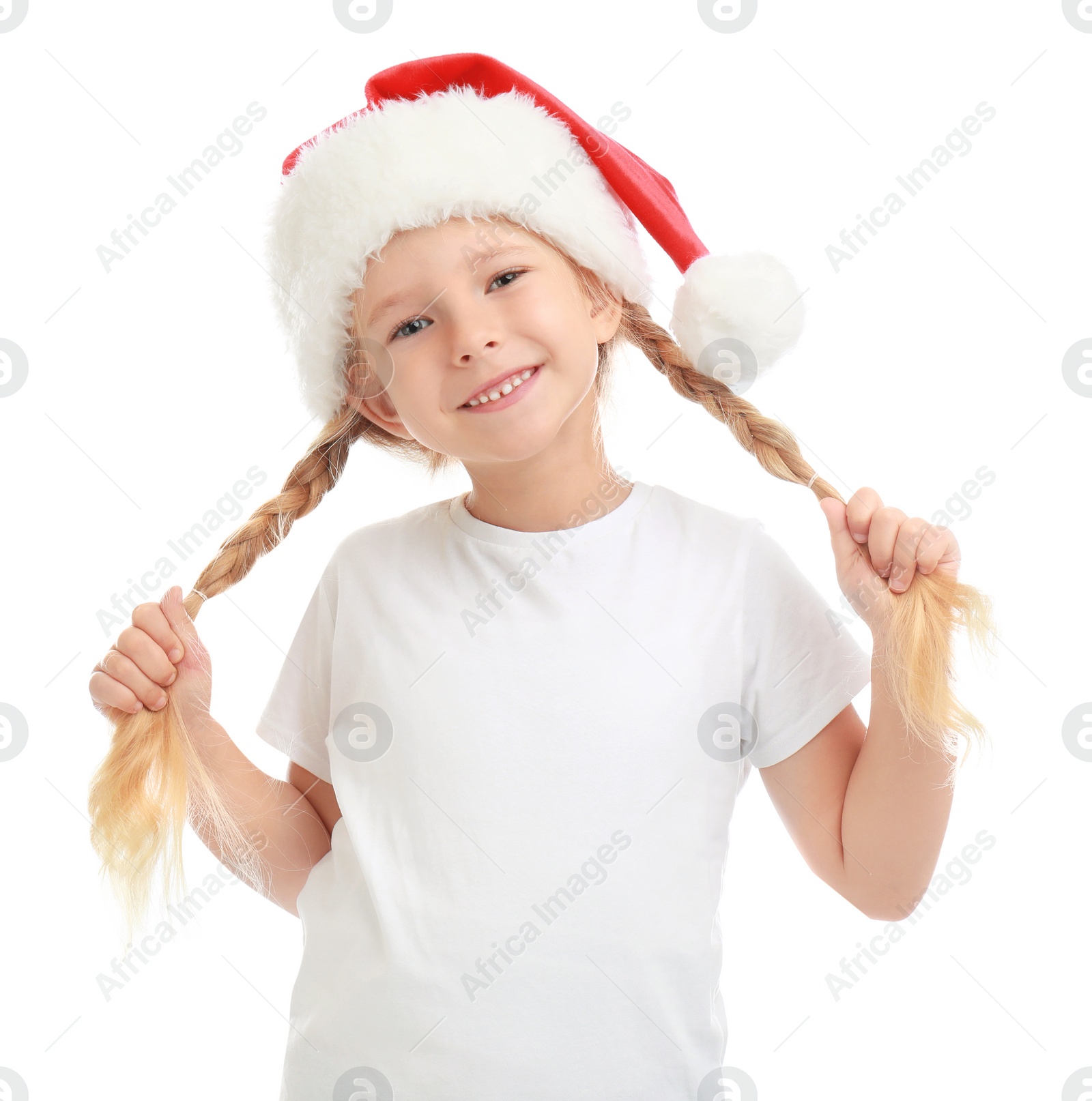 Photo of Cute little child wearing Santa hat on white background. Christmas holiday