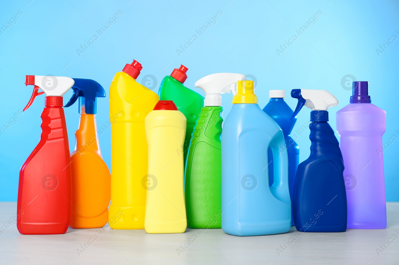 Photo of Bottles of different cleaning products on light table