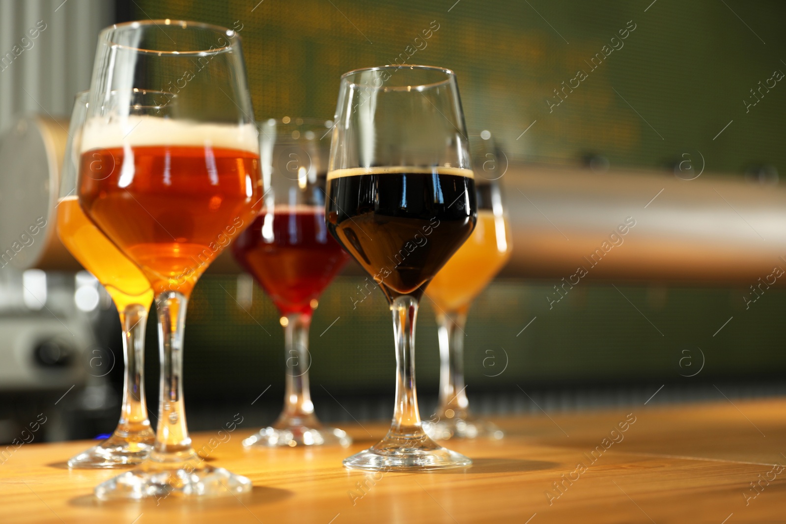 Photo of Different sorts of beer on wooden bar counter