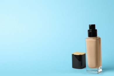 Photo of Bottle of skin foundation and space for text on color background