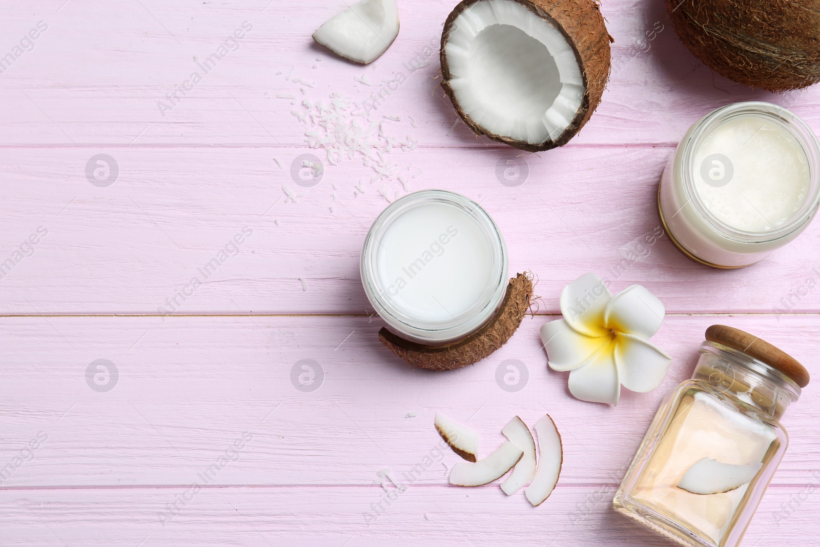 Photo of Beautiful composition with coconut oil and nuts on color wooden background