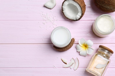 Photo of Beautiful composition with coconut oil and nuts on color wooden background