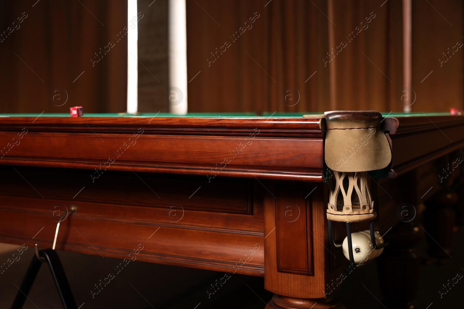 Photo of Stylish billiard table with white balls in pocket indoors