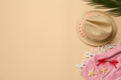Photo of Flat lay composition with straw hat on beige background. Space for text