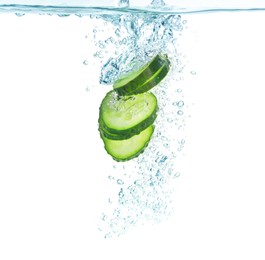 Fresh cucumber slices in water on white background