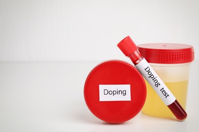 Photo of Jars and test tube with samples on beige background, space for text. Doping control