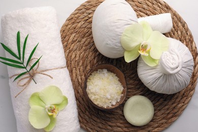 Flat lay composition with spa products and beautiful flowers on white marble table