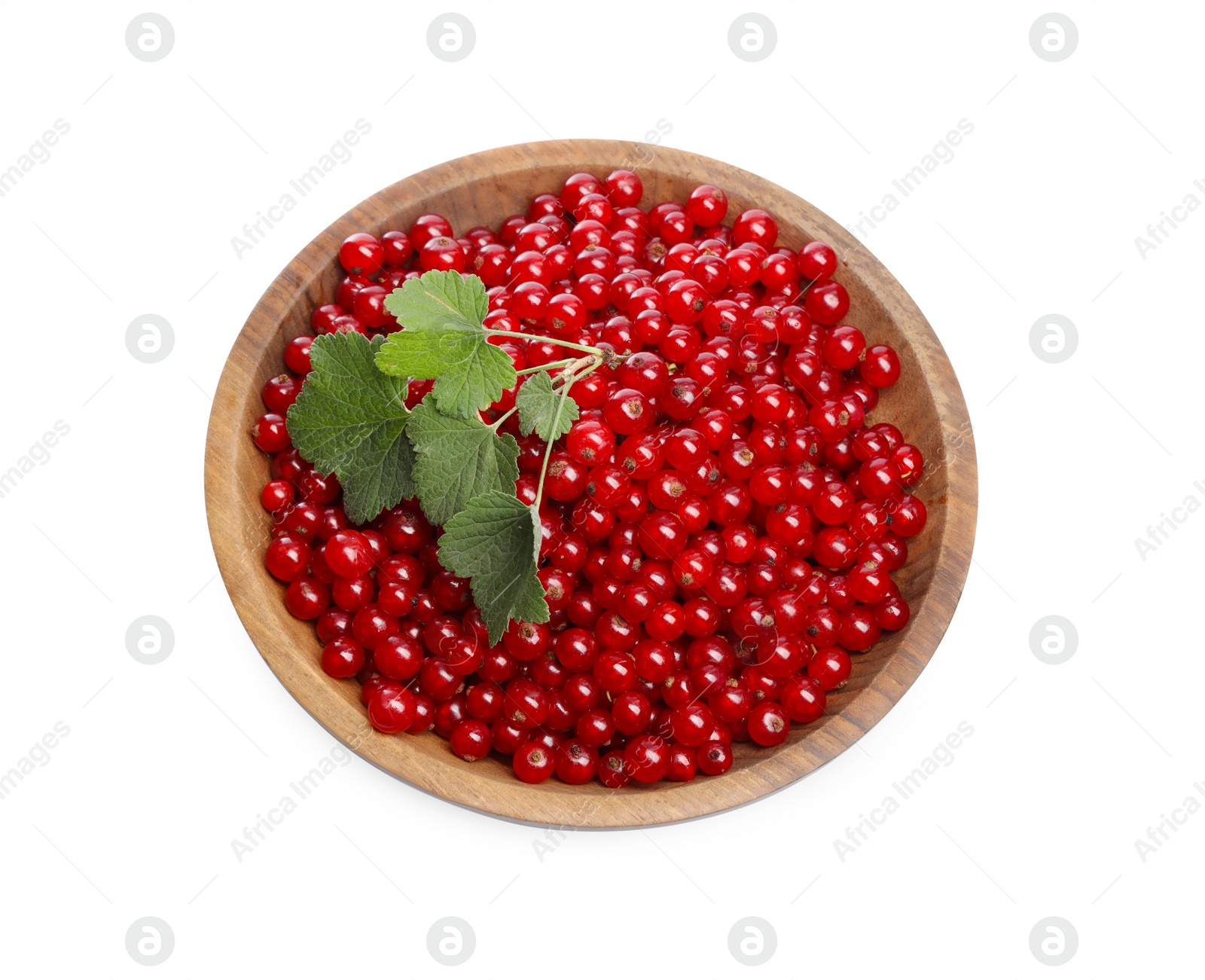 Photo of Tasty ripe red currants and green leaves in bowl isolated on white