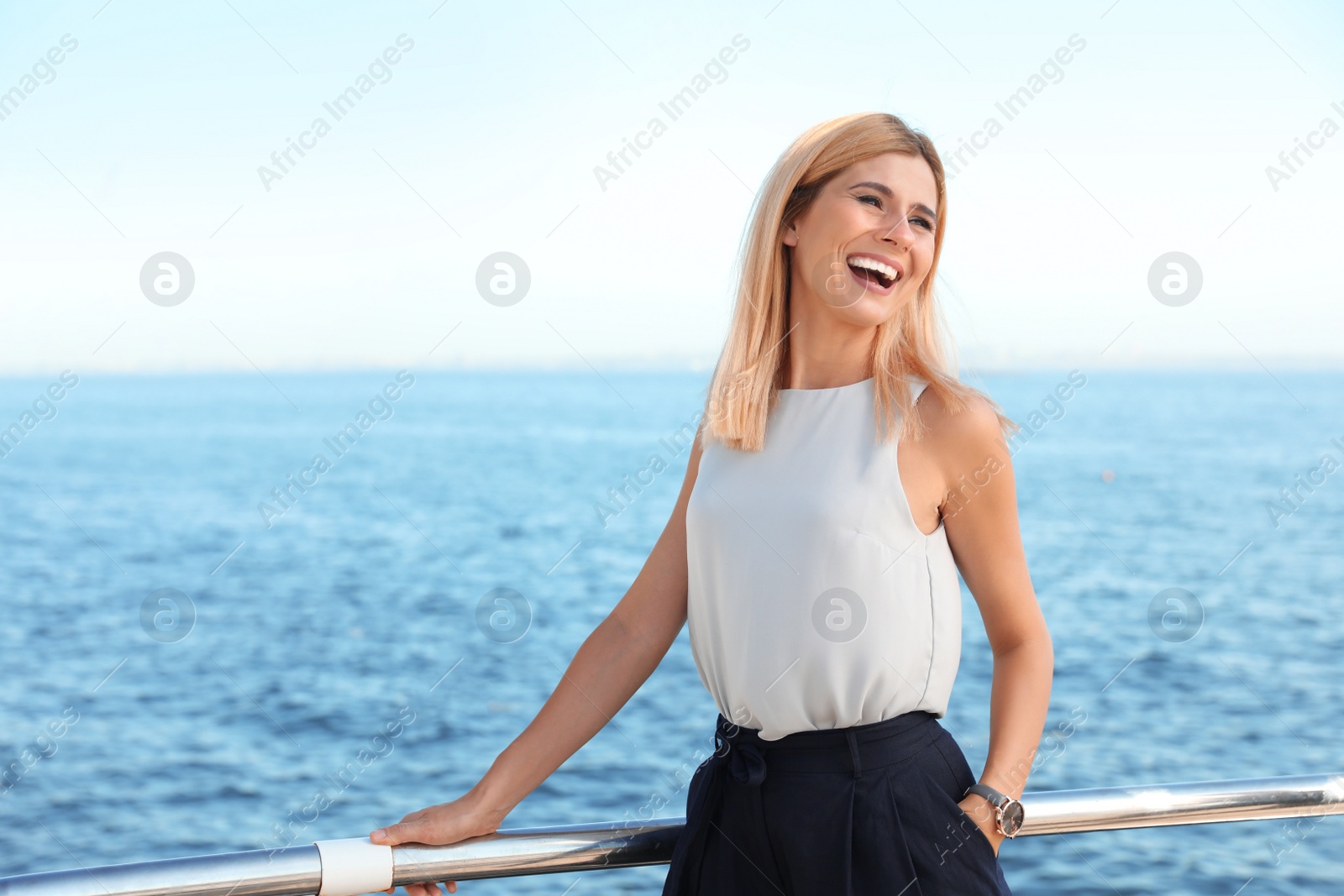 Photo of Portrait of beautiful blonde woman near sea, space for text