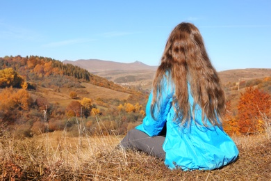 Female traveler viewing peaceful mountain landscape