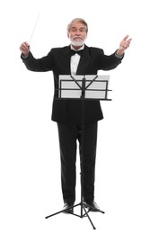 Professional conductor with baton and note stand on white background