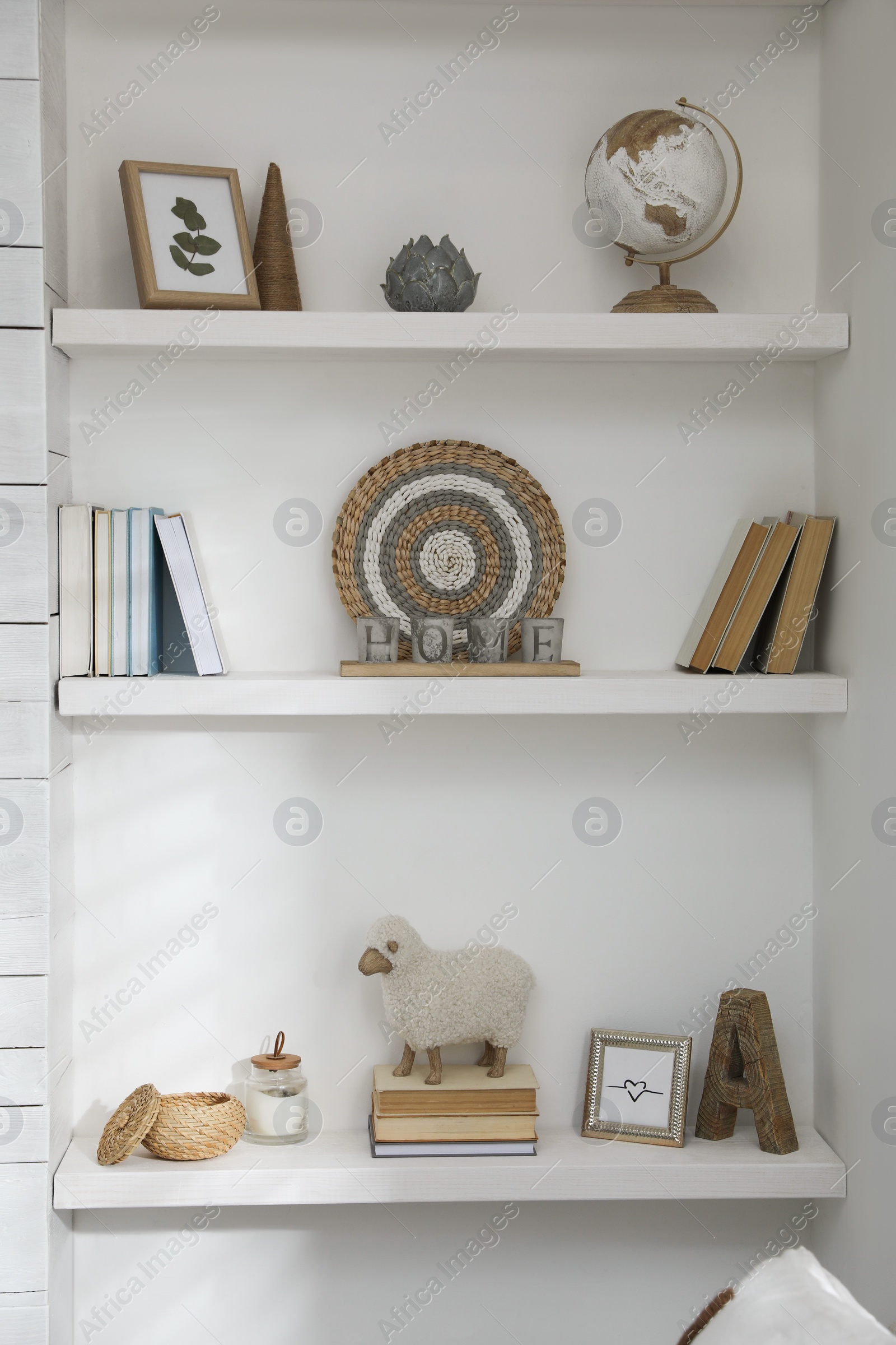 Photo of Many shelves with different decor in room. Interior design