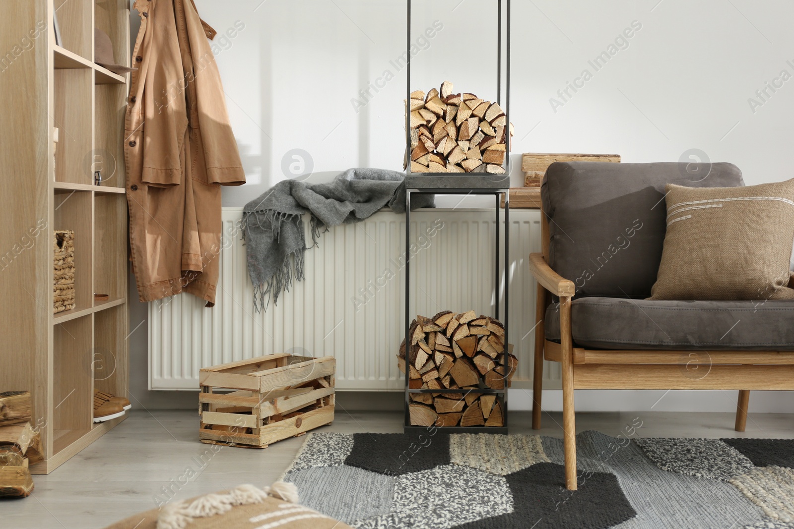 Photo of Firewood as decorative element in stylish room interior