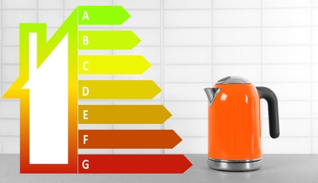 Image of Energy efficiency rating label and electric kettle on grey table