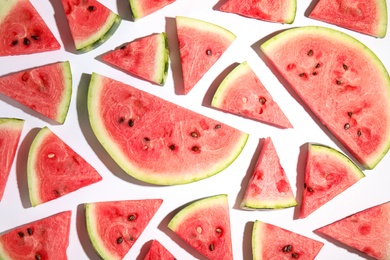 Photo of Slices of ripe watermelon on white background, flat lay