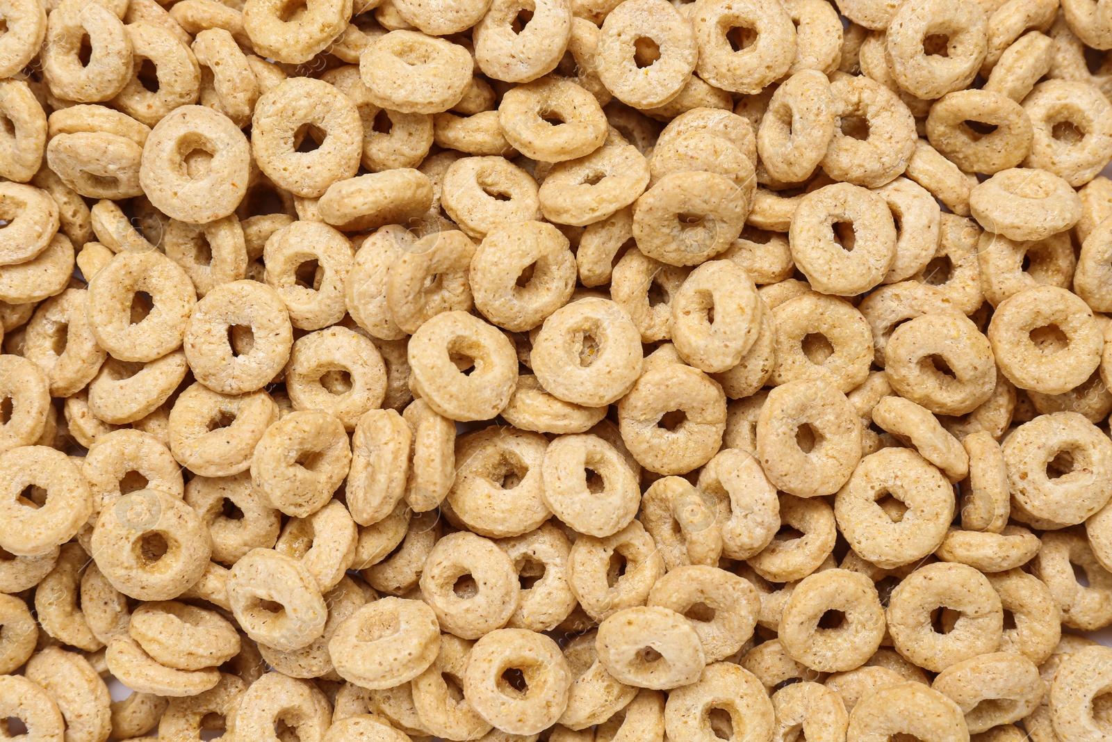 Photo of Sweet tasty corn rings as background, top view