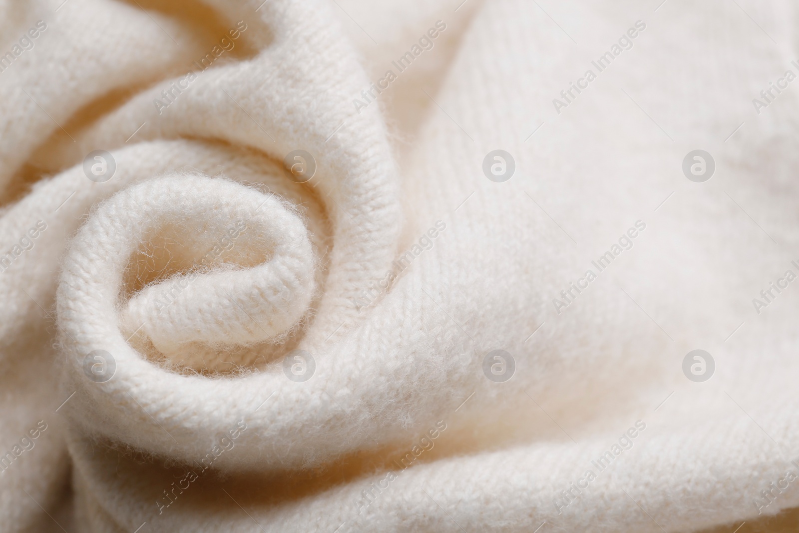 Photo of Soft beige knitted fabric as background, top view