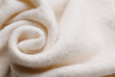 Photo of Soft beige knitted fabric as background, top view