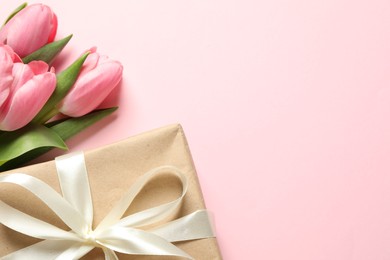 Photo of Happy Mother's Day. Beautiful tulips and gift box on pink background, flat lay. Space for text