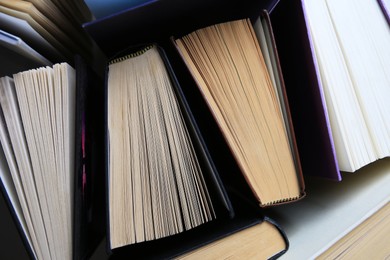 Photo of Collection of different hardcover books, closeup view