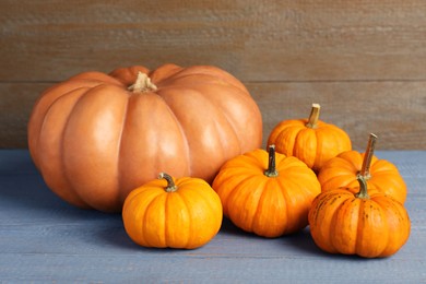 Photo of Pile of ripe pumpkins on grey wooden table