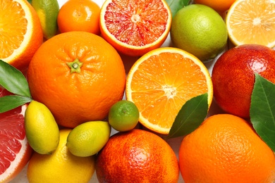 Photo of Many different citrus fruits as background, top view