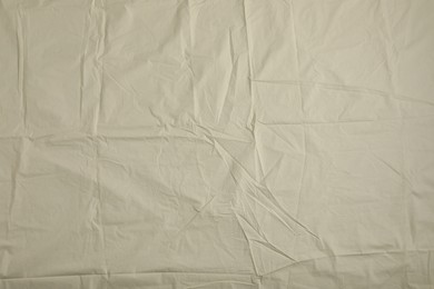 Crumpled beige fabric as background, top view