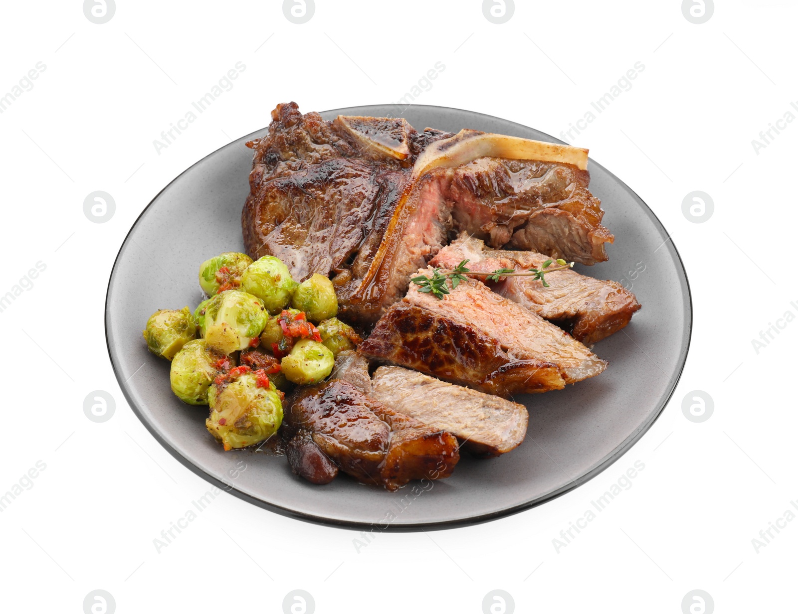 Photo of Delicious fried beef meat, vegetables and thyme isolated on white