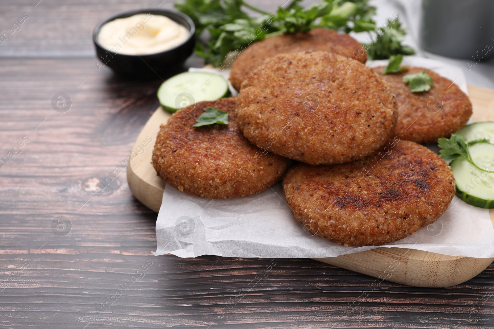 Photo of Tasty vegan cutlets served on wooden table, closeup