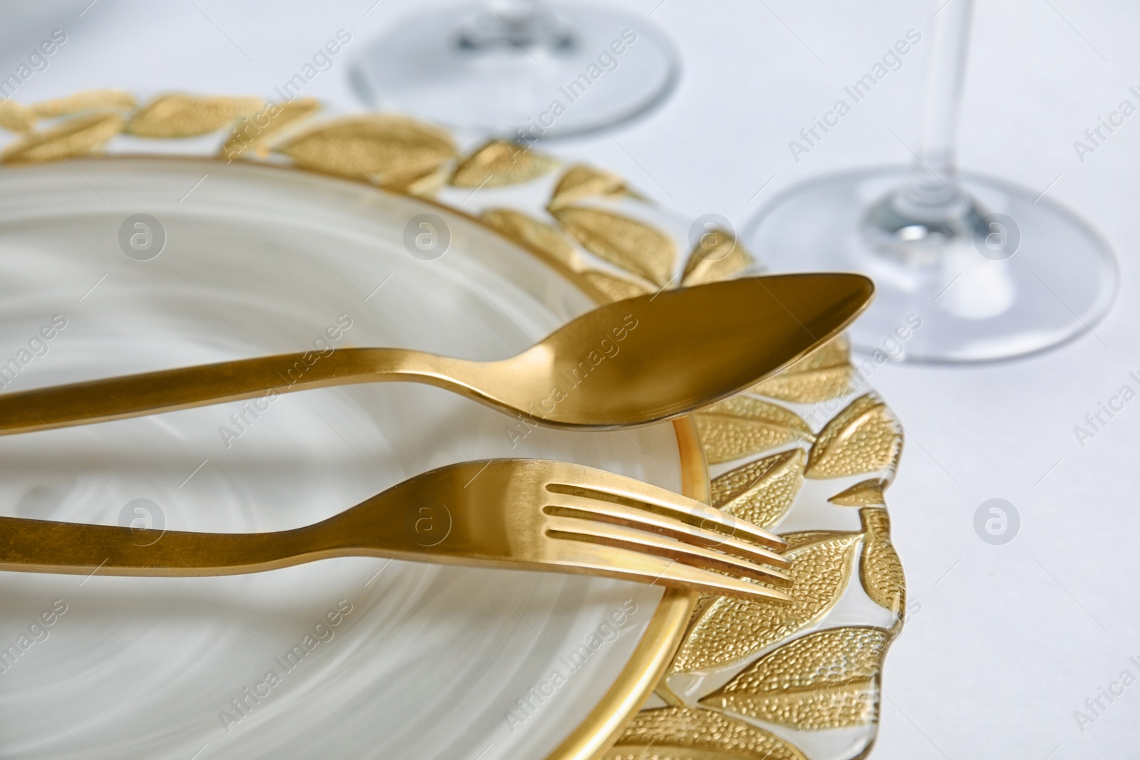 Photo of Elegant table setting on light background, closeup