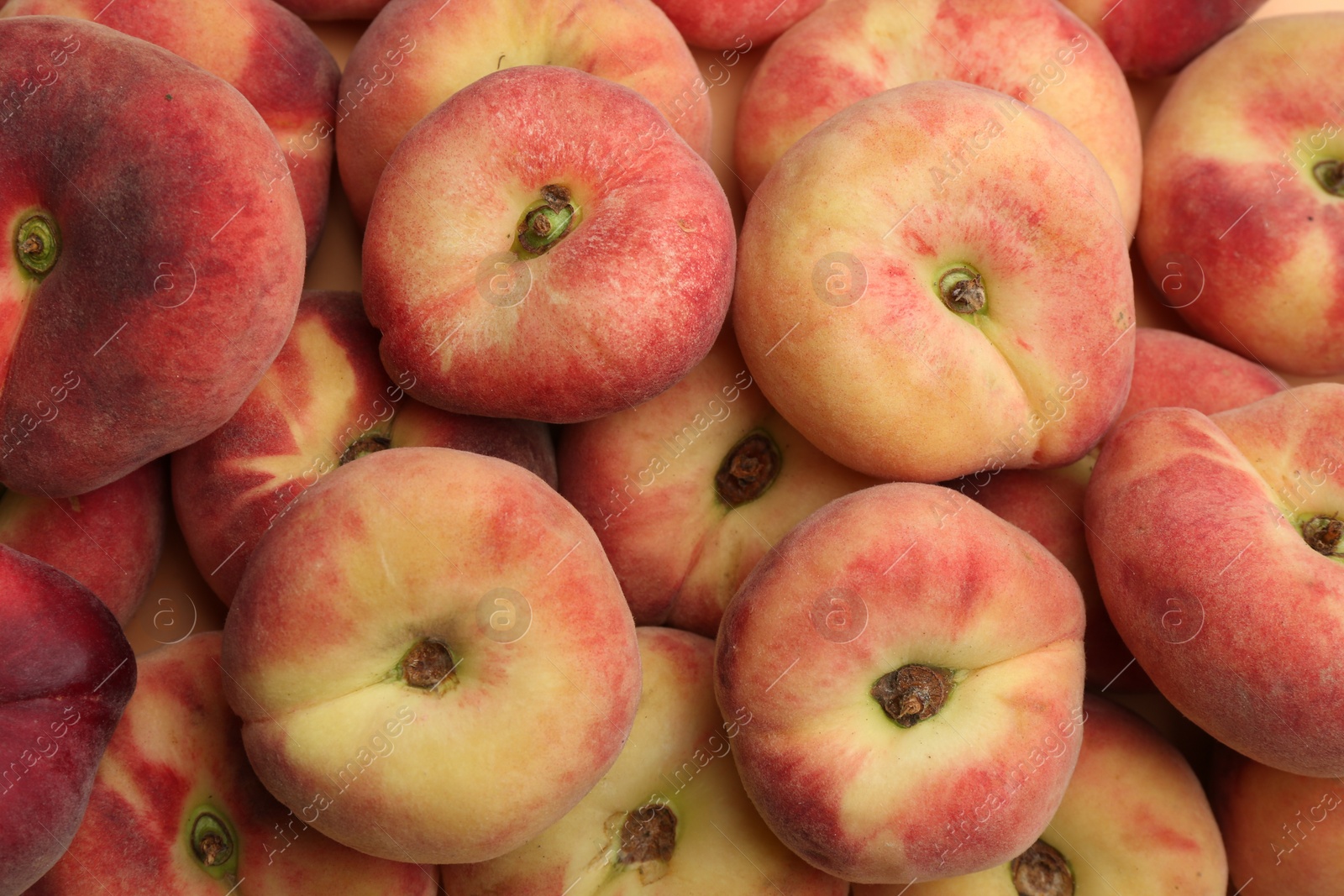 Photo of Heap of fresh donut peaches as background, closeup