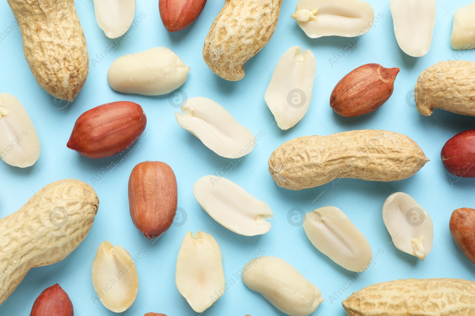 Photo of Fresh peanuts on light blue background, flat lay