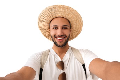 Smiling young man in straw hat taking selfie on white background