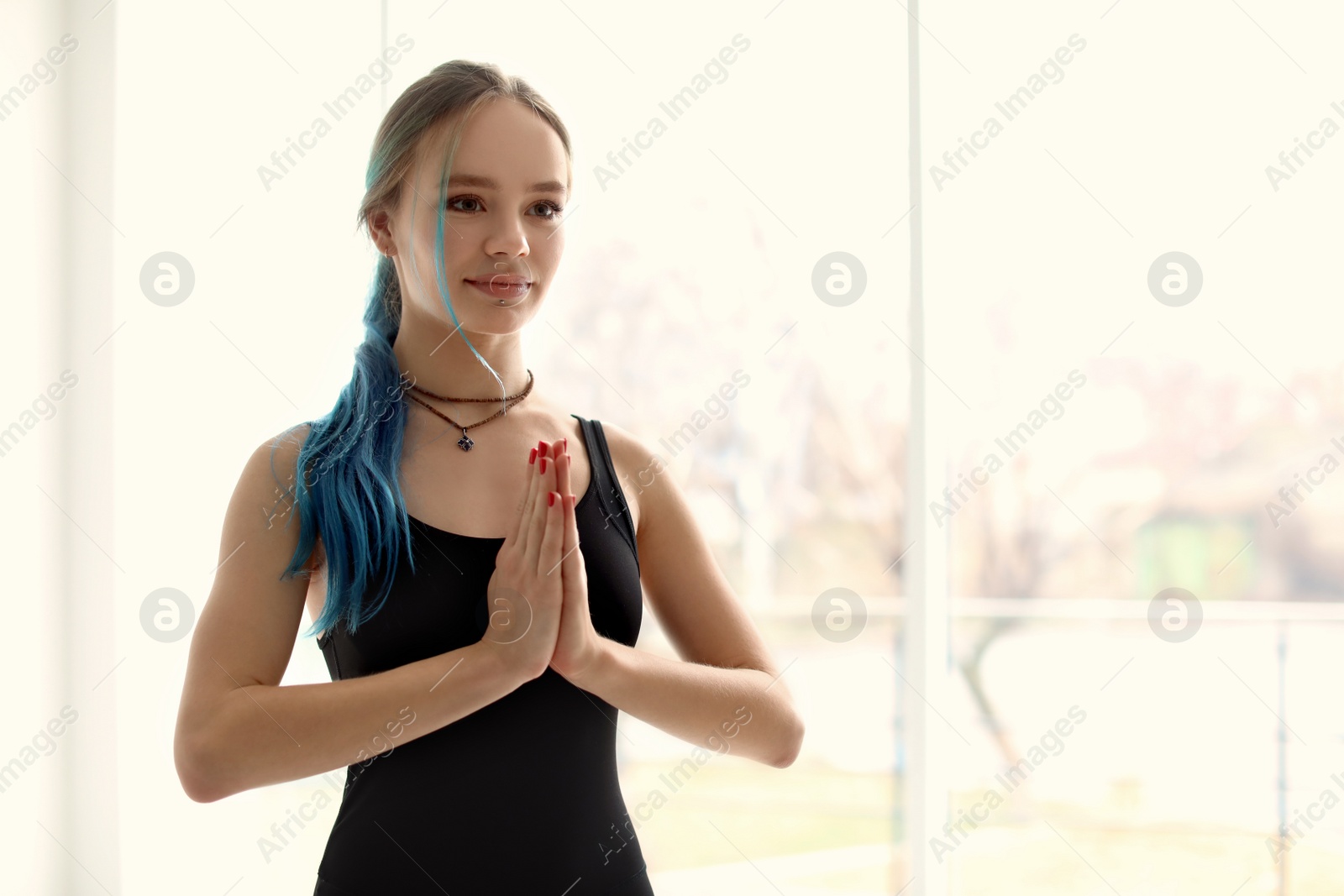 Photo of Young woman practicing yoga indoors