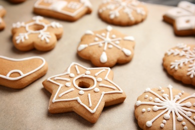 Photo of Tasty homemade Christmas cookies on parchment paper, closeup