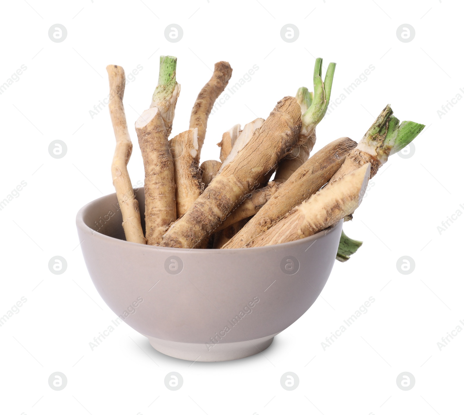 Photo of Cut horseradish roots in bowl isolated on white