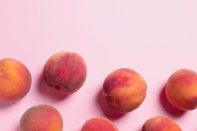 Photo of Many whole fresh ripe peaches on pink background, flat lay. Space for text