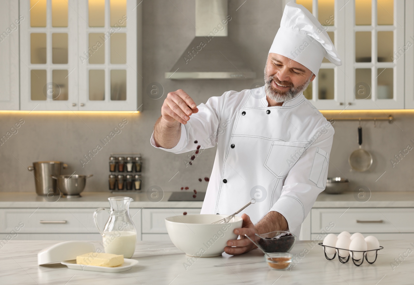 Photo of Professional chef making dough at white marble table in kitchen