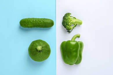 Flat lay composition with fresh vegetables on color background