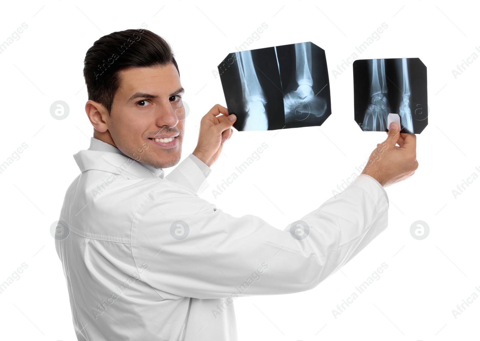 Photo of Orthopedist holding X-ray pictures on white background