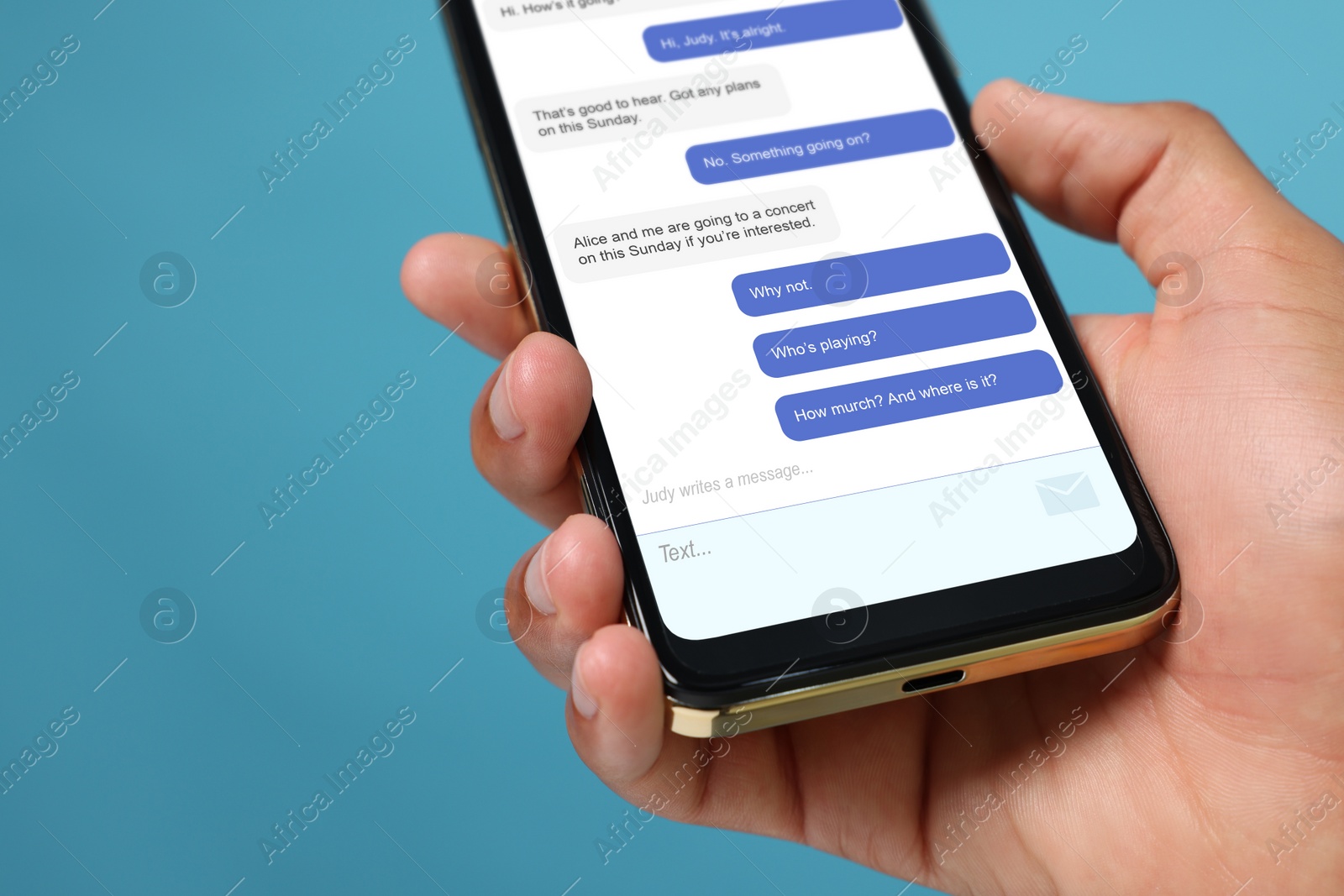 Image of Man texting with friend using messaging application on smartphone against light blue background, closeup