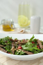 Photo of Delicious salad with beef tongue, arugula and seeds on table