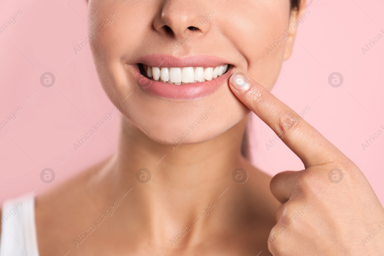 Photo of Young woman with healthy teeth on color background, closeup