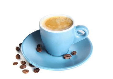 Photo of Cup of tasty espresso and scattered coffee beans on white background