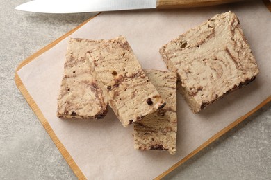 Photo of Tasty chocolate halva on grey table, top view