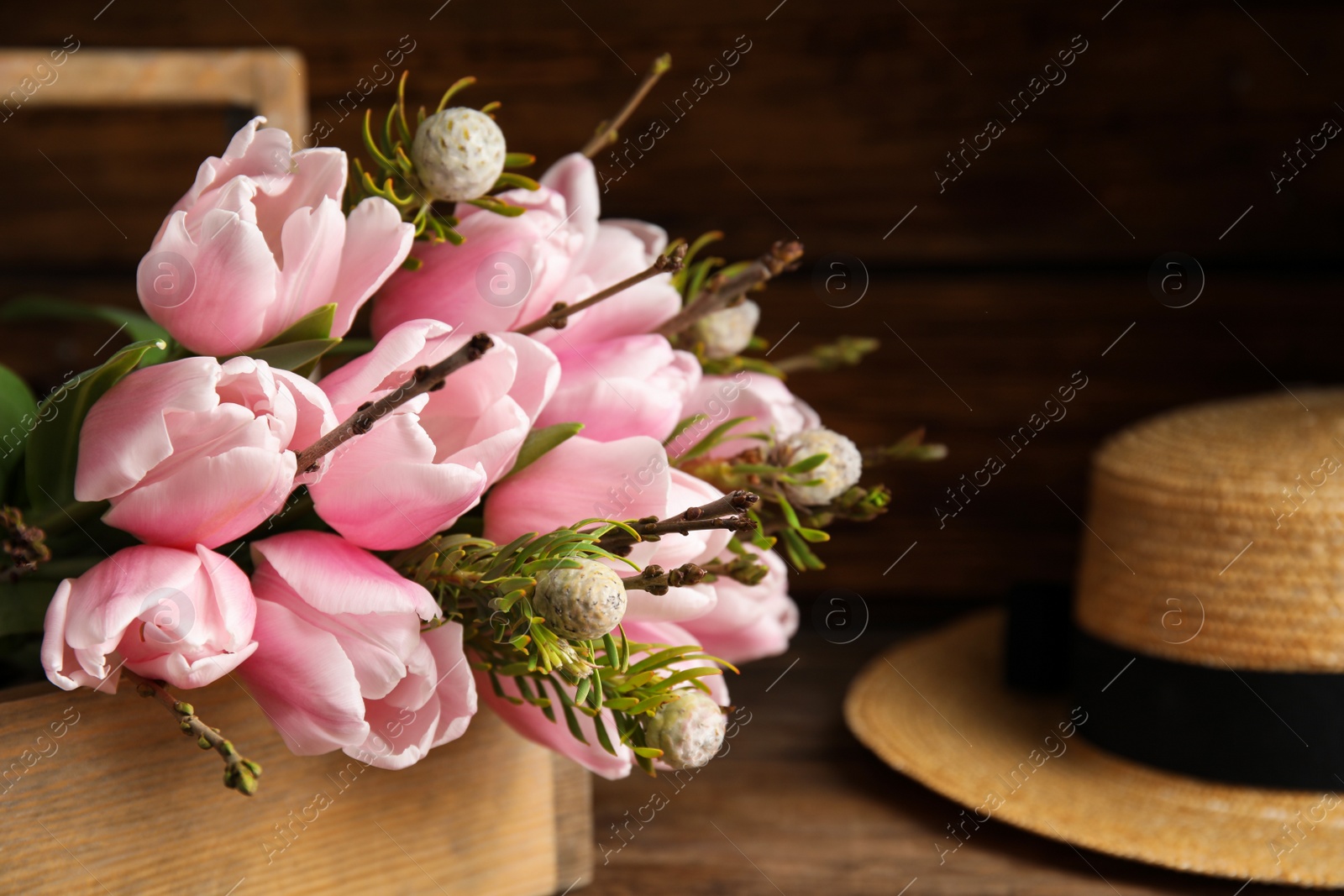 Photo of Beautiful bouquet of spring pink tulips on wooden table, closeup